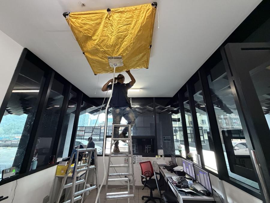 Cassette aircond canvas wash: catch bag sealed under a ceiling cassette in a condo guard house